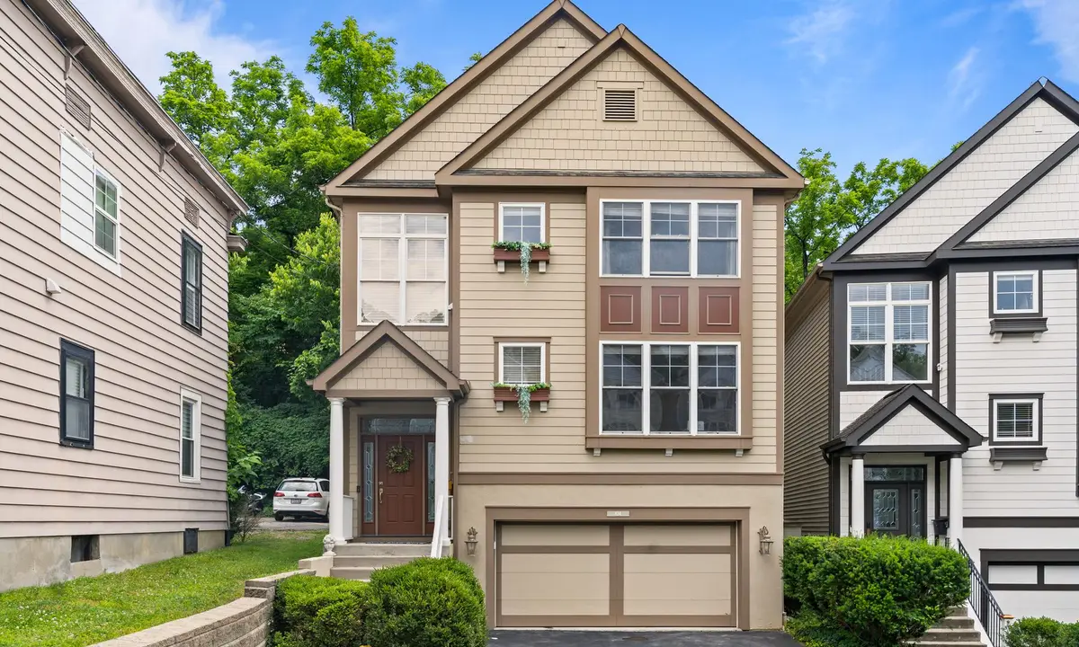 Suburban house with an attached garage between neighboring homes