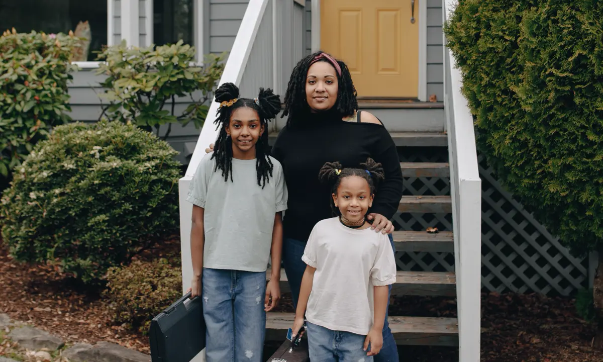 A family standing in front of their home