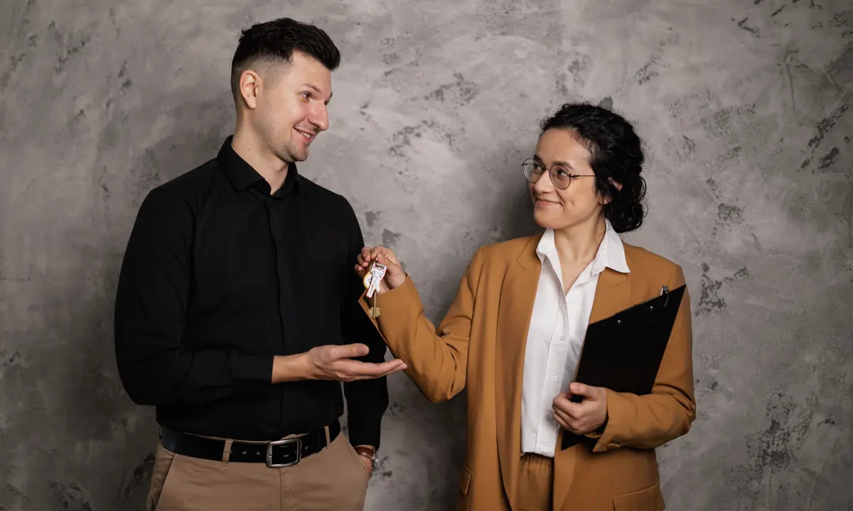 Real-estate professional handing keys to a new homeowner