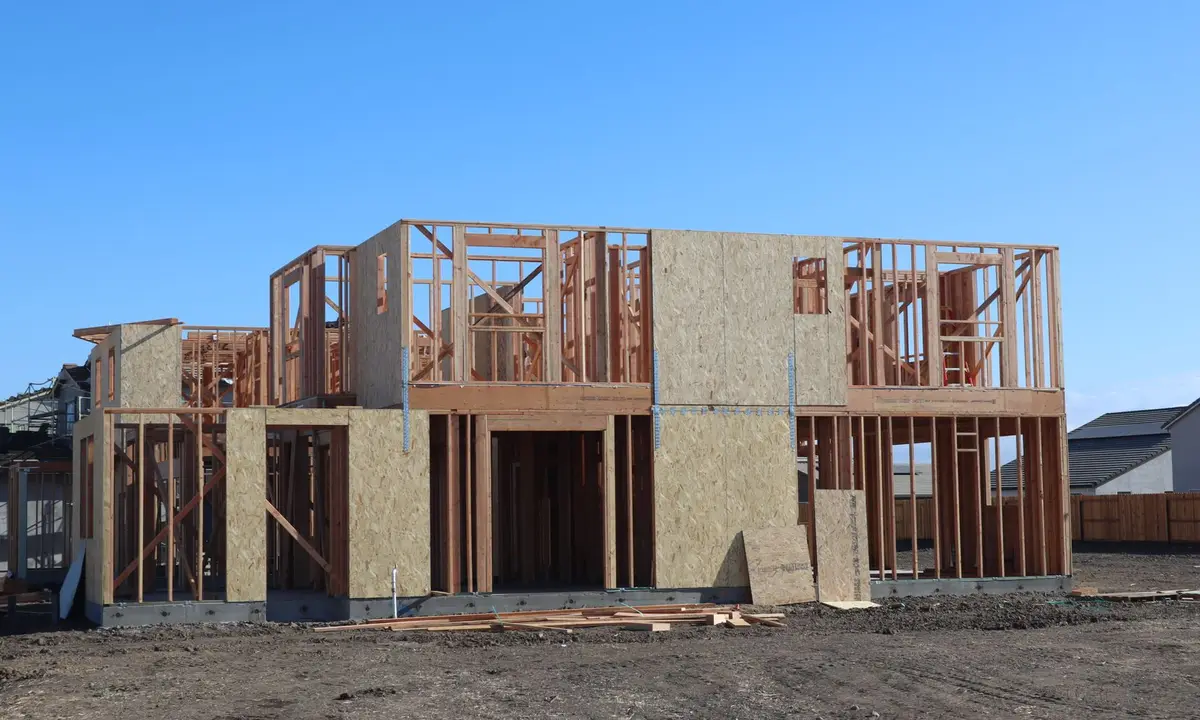 Two-story house in the wood framing stage at a new subdivision