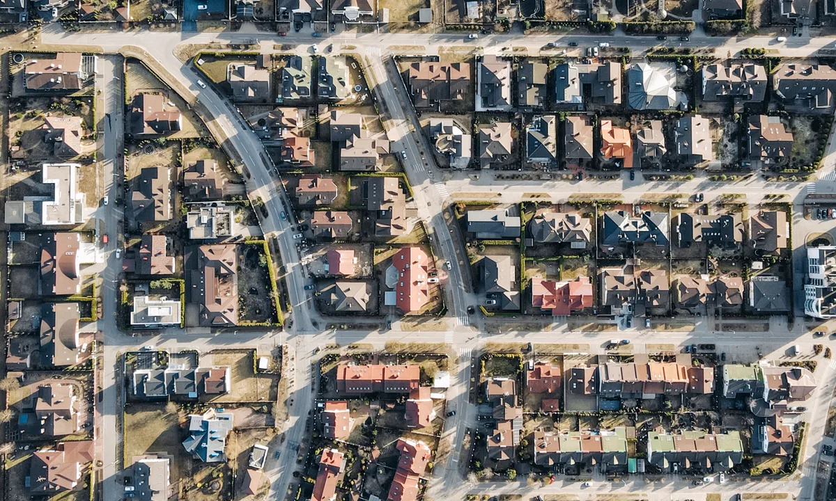 Aerial view of residential parcels, homes, and neighborhood streets