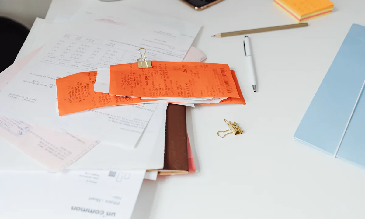 Property-related receipts and documents organized on a desk